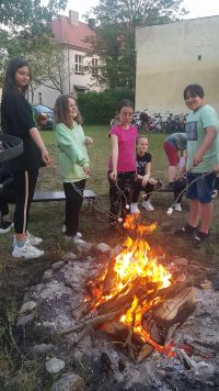 Czworo dzieci piecze pianki w ognisku
